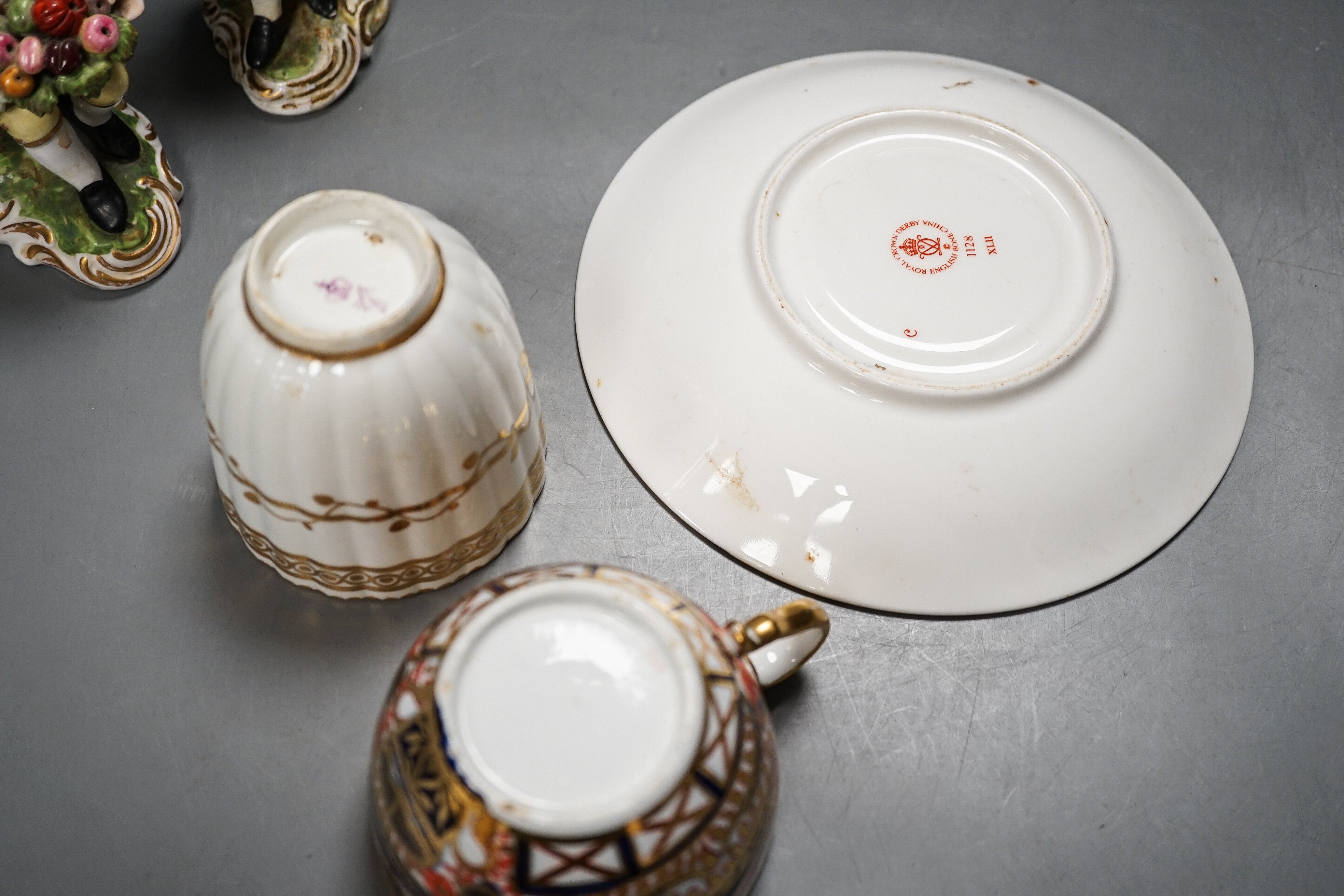 A Derby Imari saucer, a similar tea cup, a pair of Sampson Hancock, Derby figures, and a Derby cup, tallest figure 13 cms high.